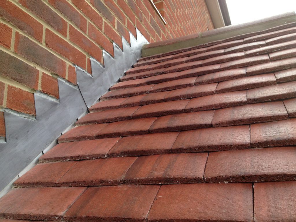 Freshly dressed lead step flashing against brick by HomeShield in Dorset